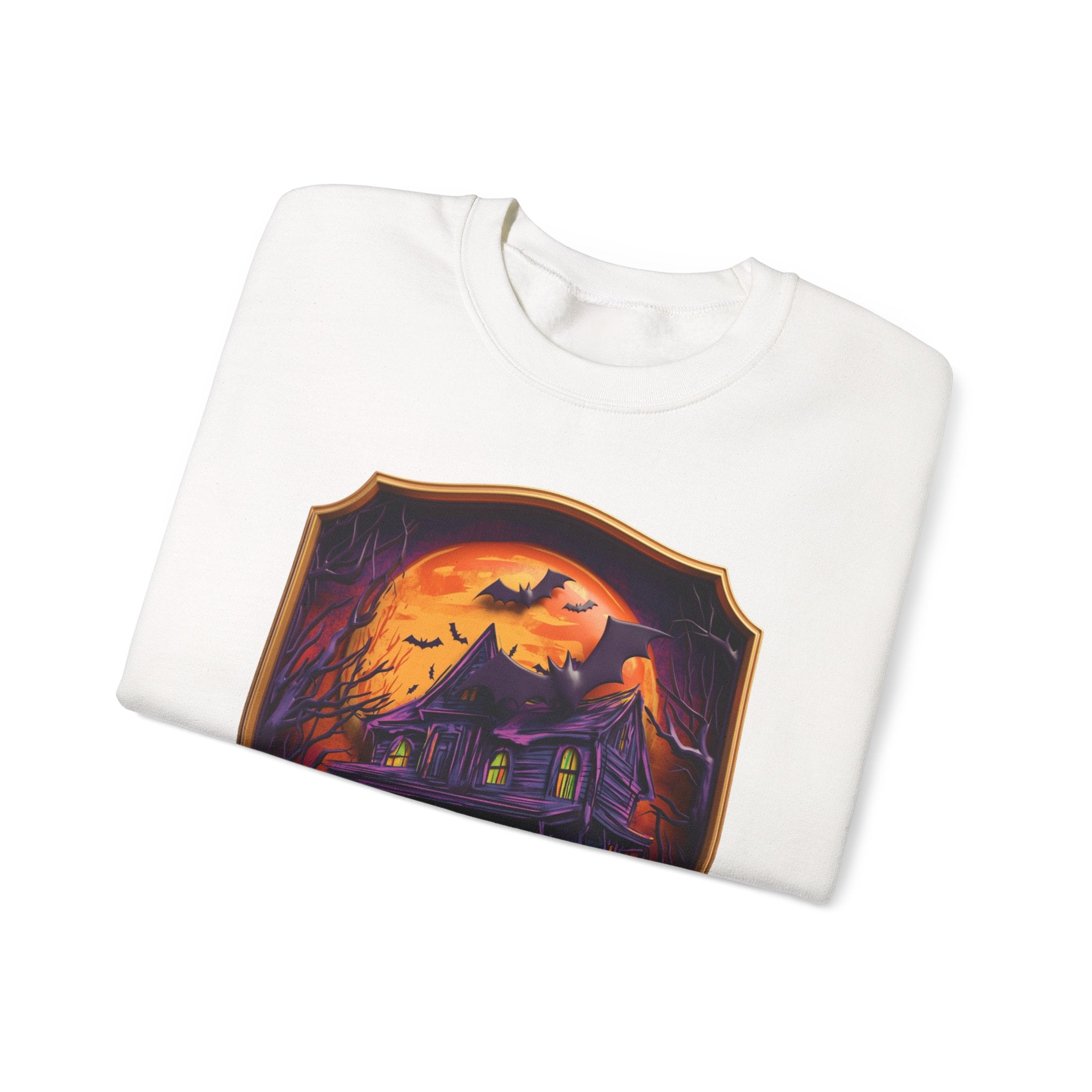 White crewneck sweatshirt folded to show the purple haunted mansion sits under a blazing orange moon print