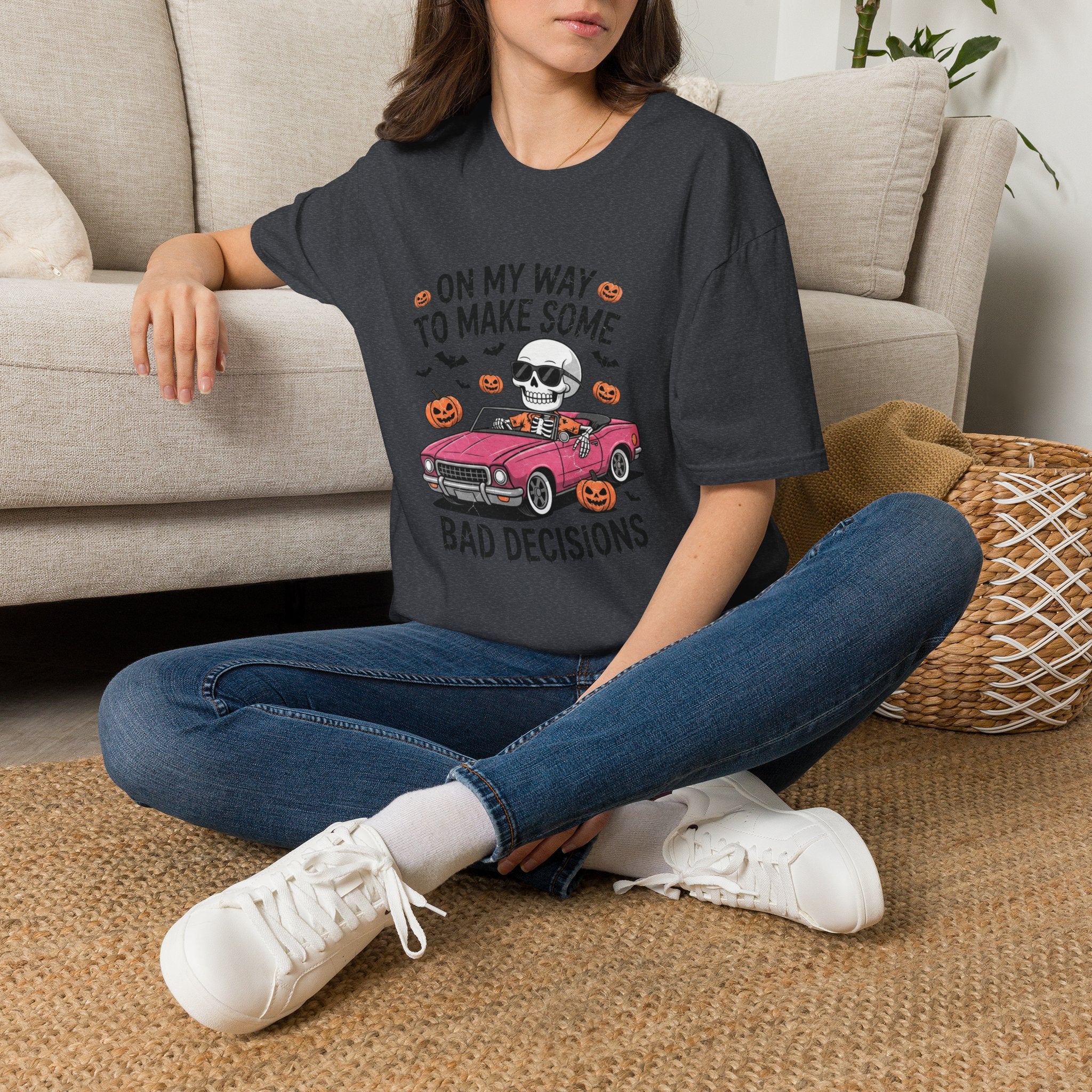 Dark Heather Grey t-shirt laid flat, printed with a pink convertible car and a skull