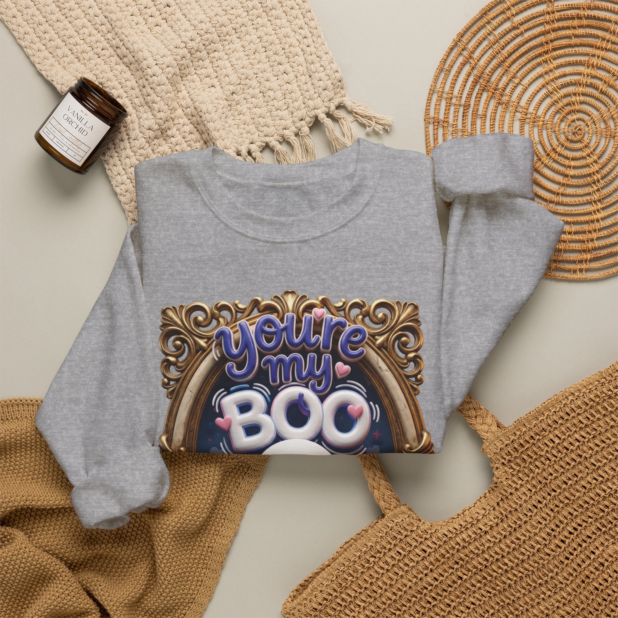 Sport Grey crewneck sweatshirt styled flat with a candle — smiling ghost in a gilded frame