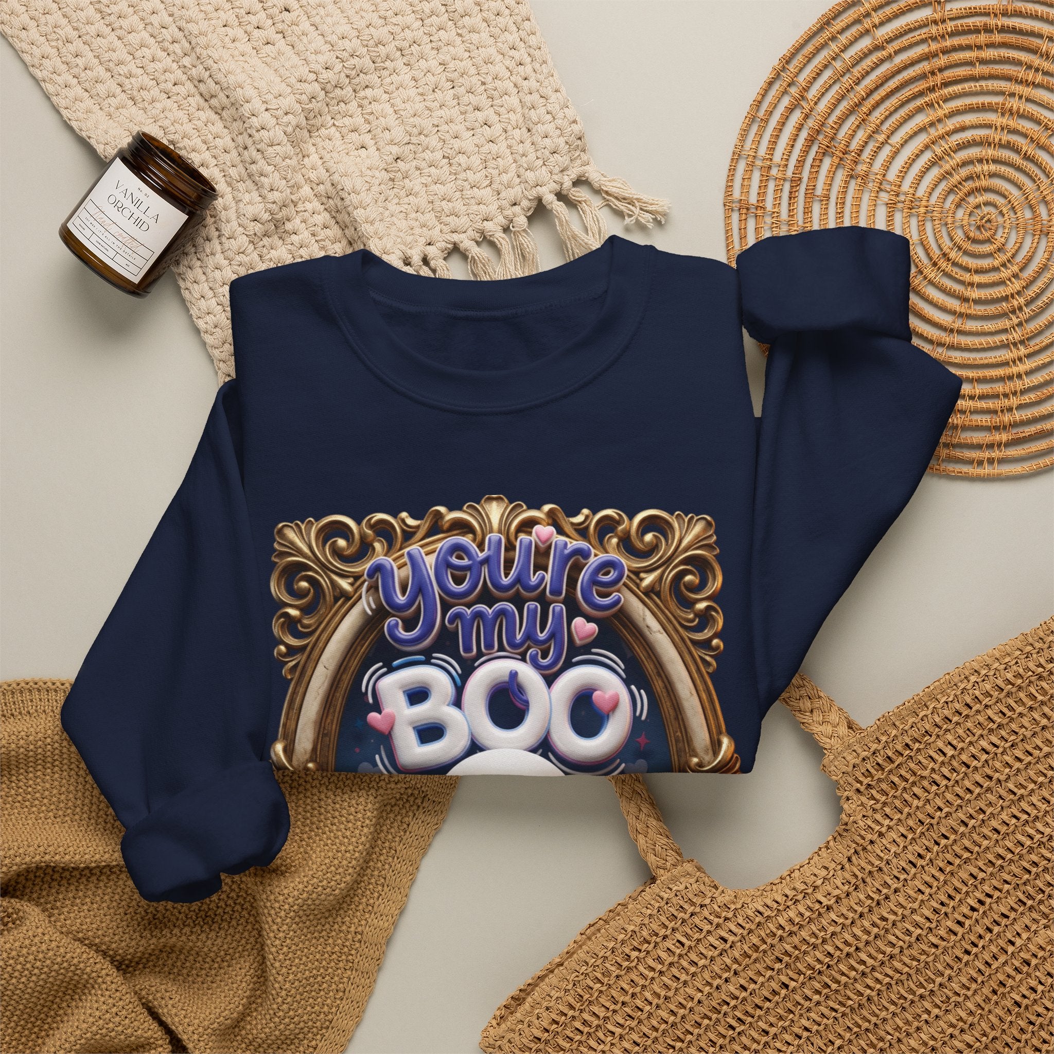 Navy crewneck sweatshirt styled flat with a candle — smiling ghost in a gilded frame