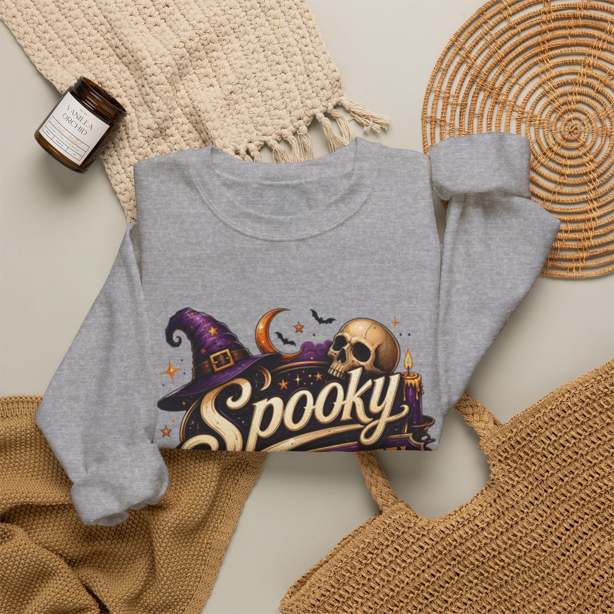 Sport Grey crewneck sweatshirt styled flat with a candle — neon Spooky Witch Motel sign