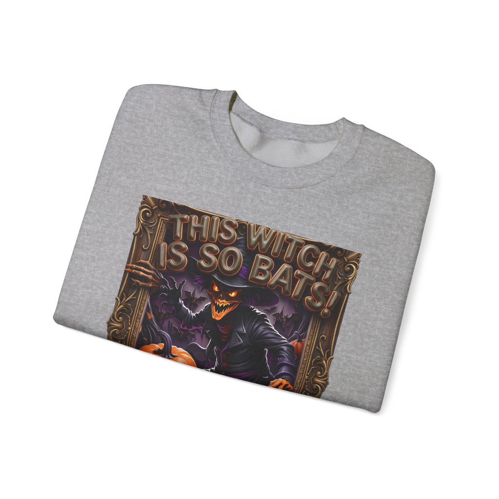 Sport Grey crewneck sweatshirt folded to show the grinning witch in a pointed hat looms over glowing print