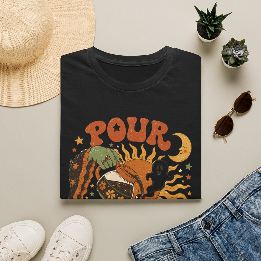 Black t-shirt styled flat with a candle — green witch hand pouring coffee