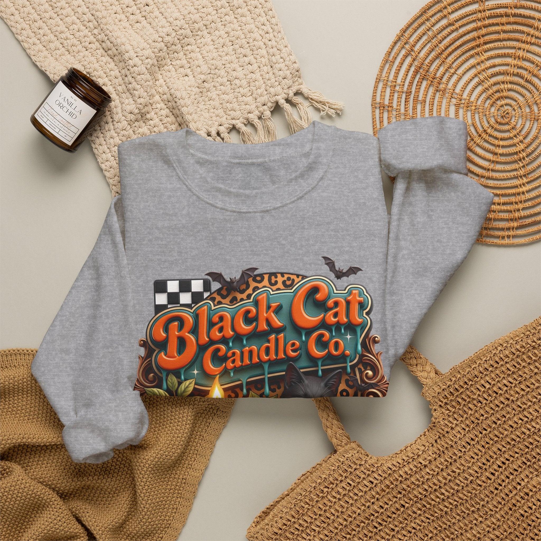Sport Grey crewneck sweatshirt styled flat with a candle — retro Black Cat Candle Co signboard