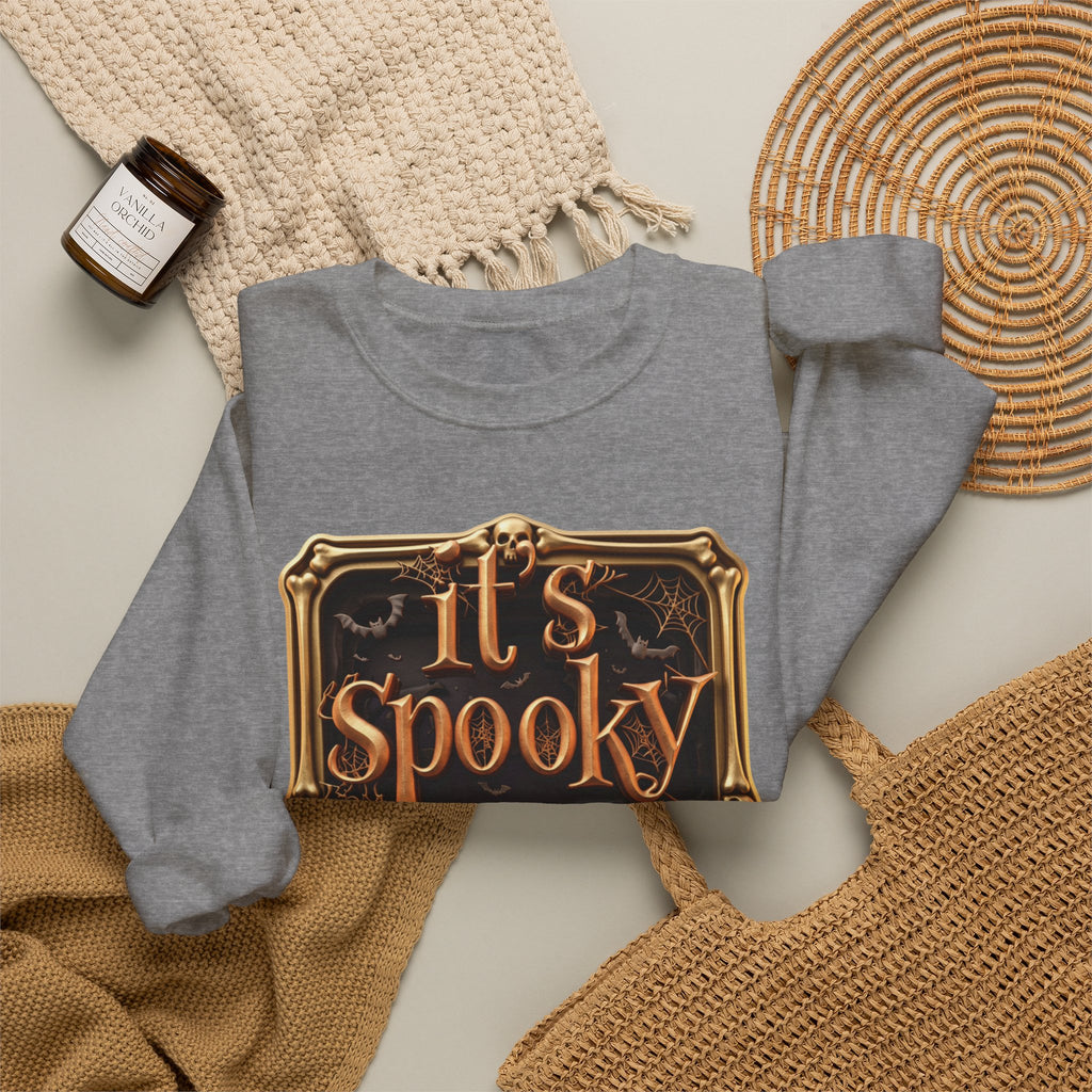 Graphite Heather crewneck sweatshirt styled flat with a candle — copper It's Spooky Season lettering
