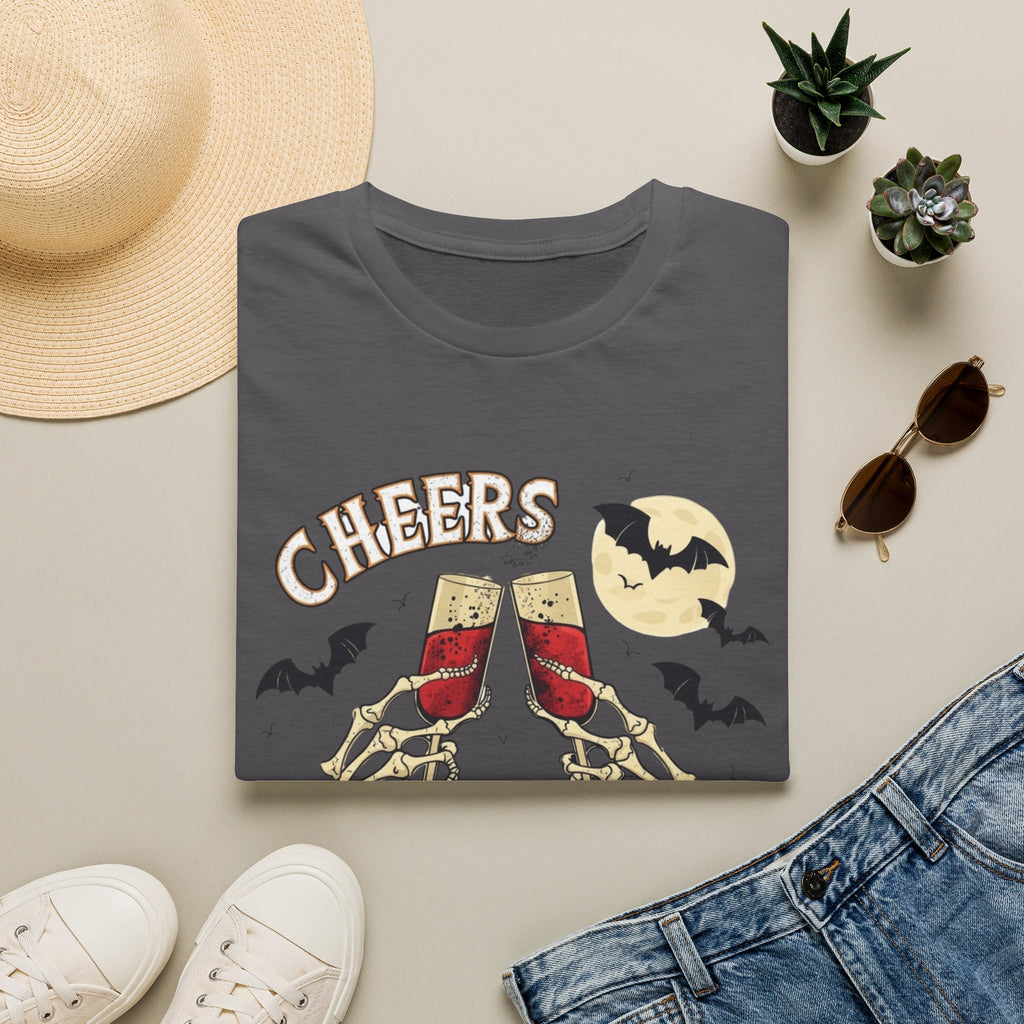 Charcoal t-shirt styled flat with a candle — skeleton hands toasting champagne