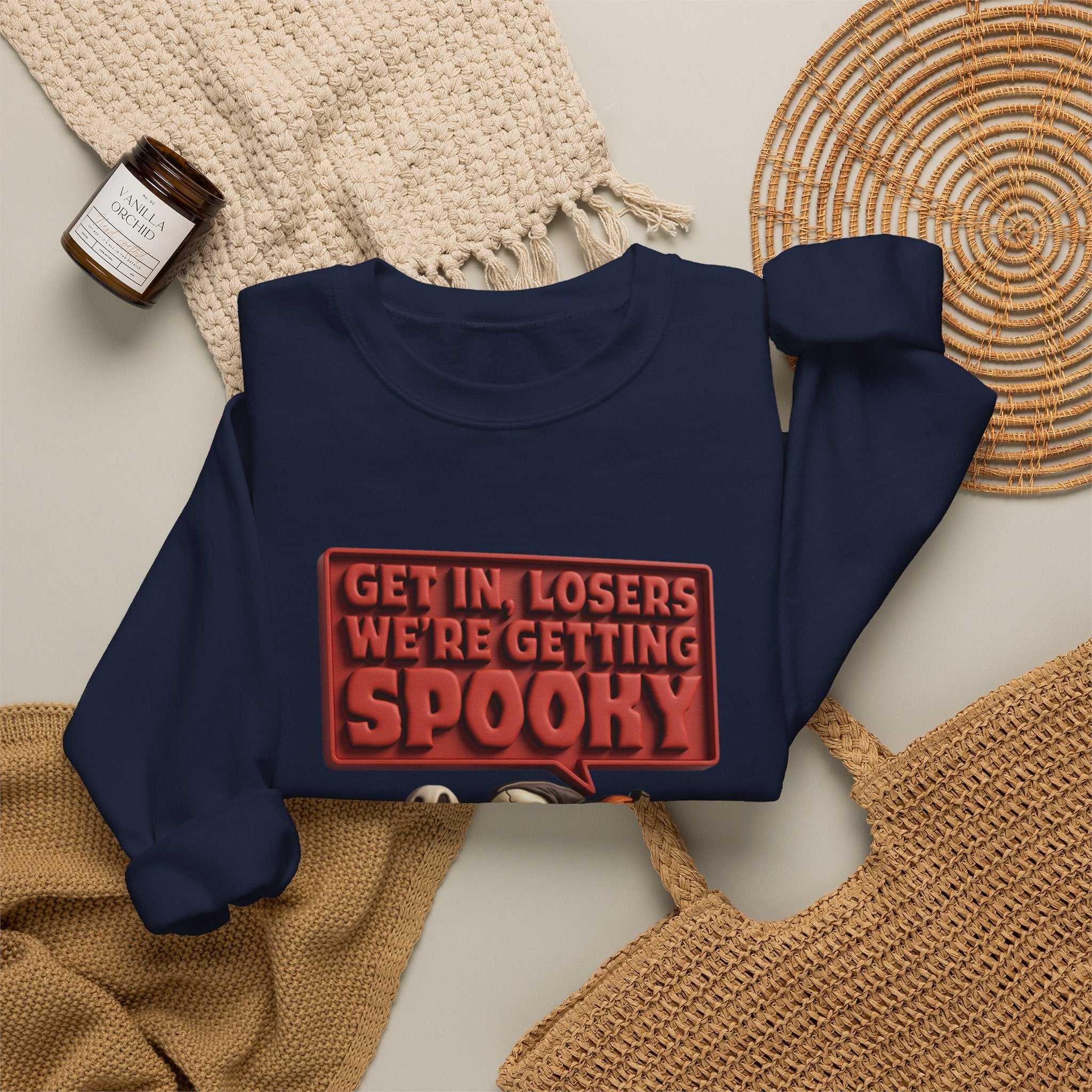 Navy crewneck sweatshirt styled flat with a candle — ghosts in a retro convertible