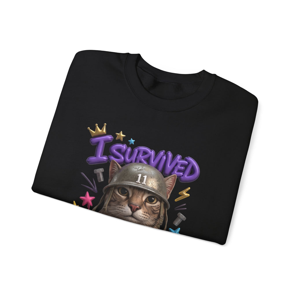Black crewneck sweatshirt folded to show the flat-eyed cat wearing a battered steel helmet print