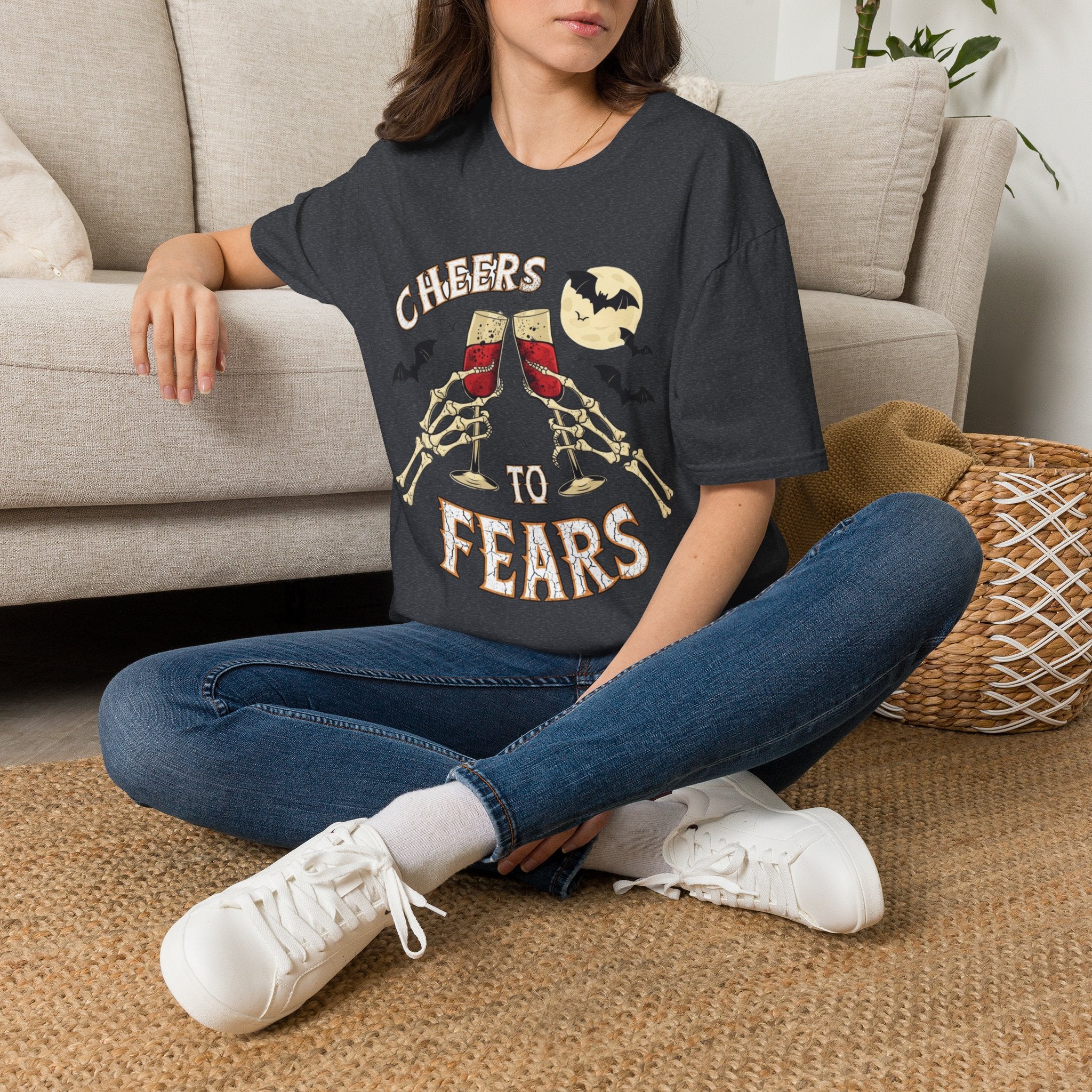 Dark Heather Grey t-shirt laid flat, printed with a two skeleton hands toasting champagne glasses with bats above