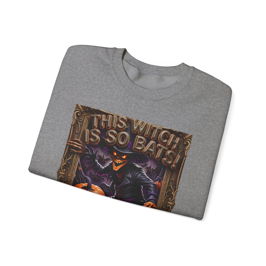 Graphite Heather crewneck sweatshirt folded to show the grinning witch in a pointed hat looms over glowing print