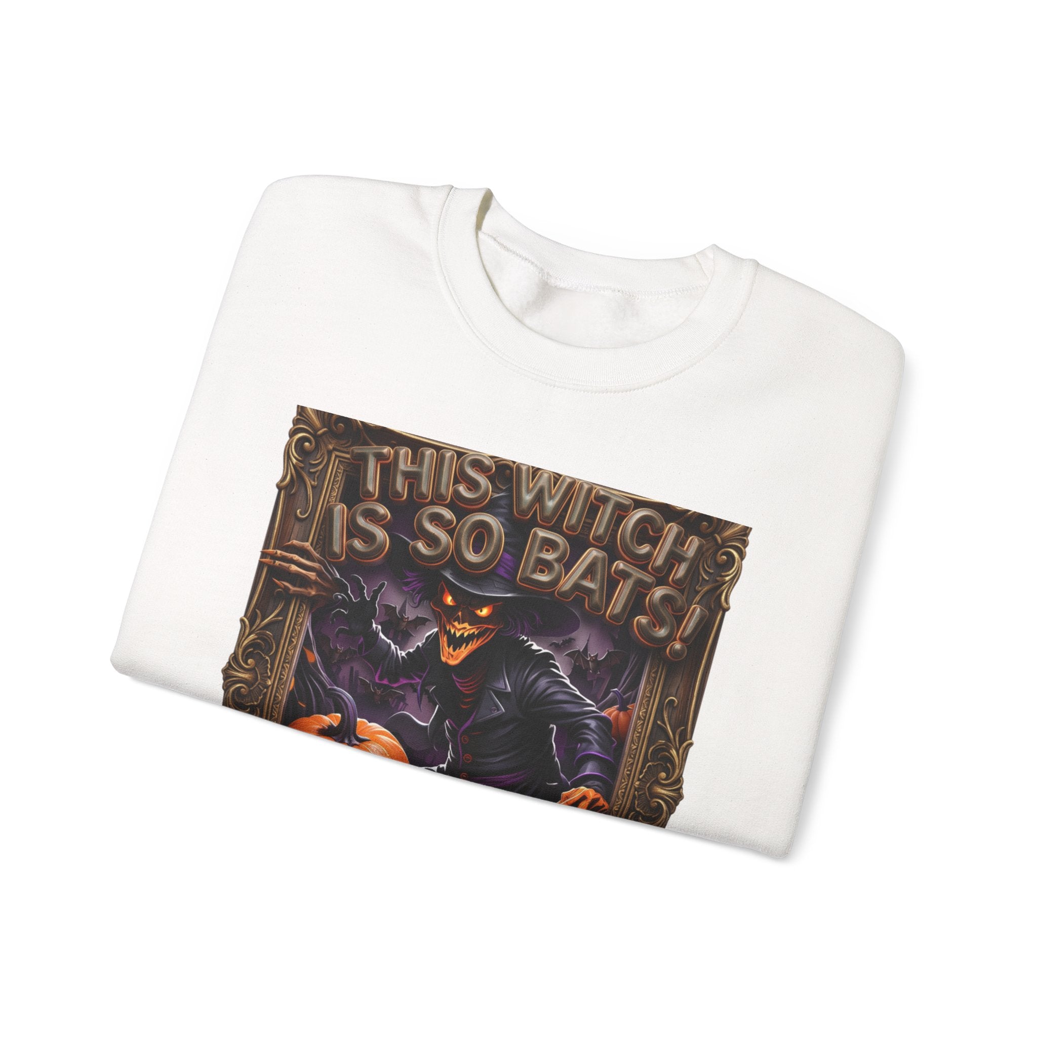 White crewneck sweatshirt folded to show the grinning witch in a pointed hat looms over glowing print