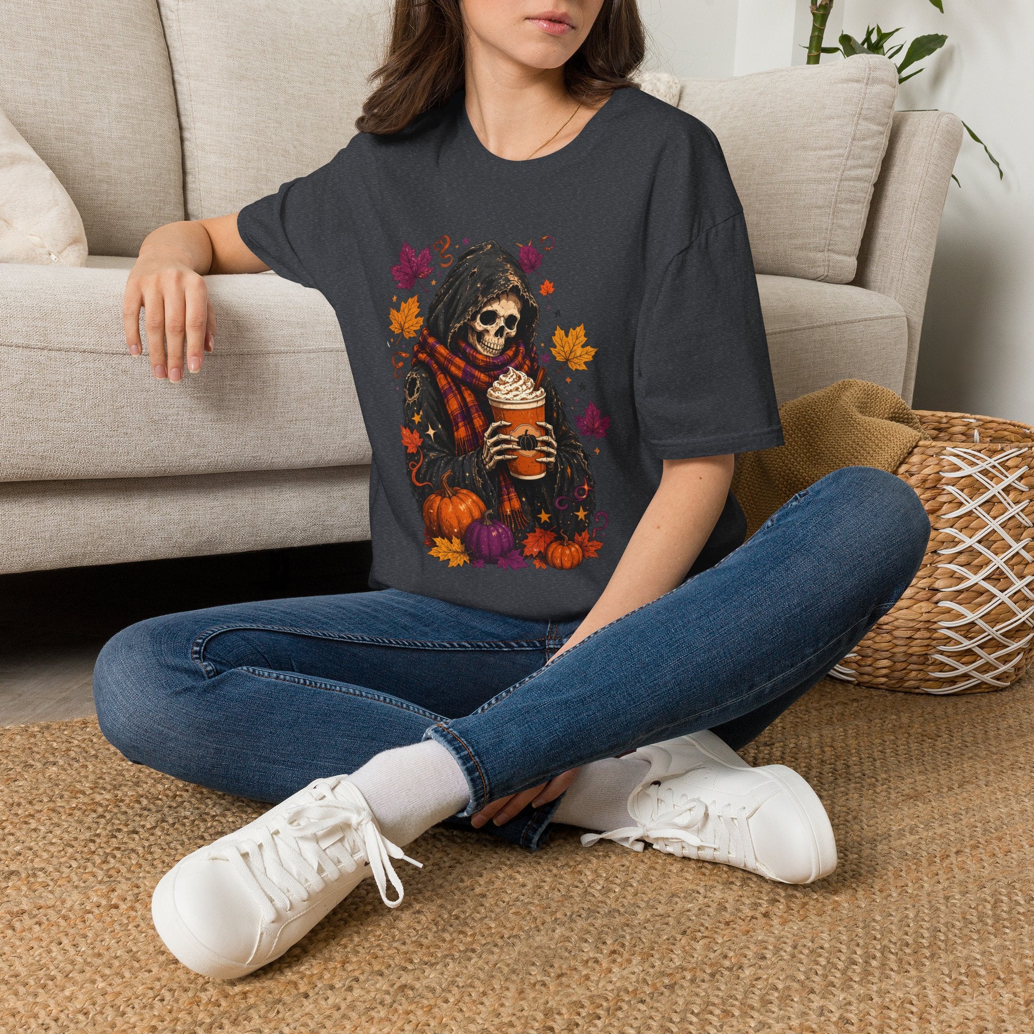 Dark Heather Grey t-shirt laid flat, printed with a hooded reaper holding a pumpkin spice drink among falling