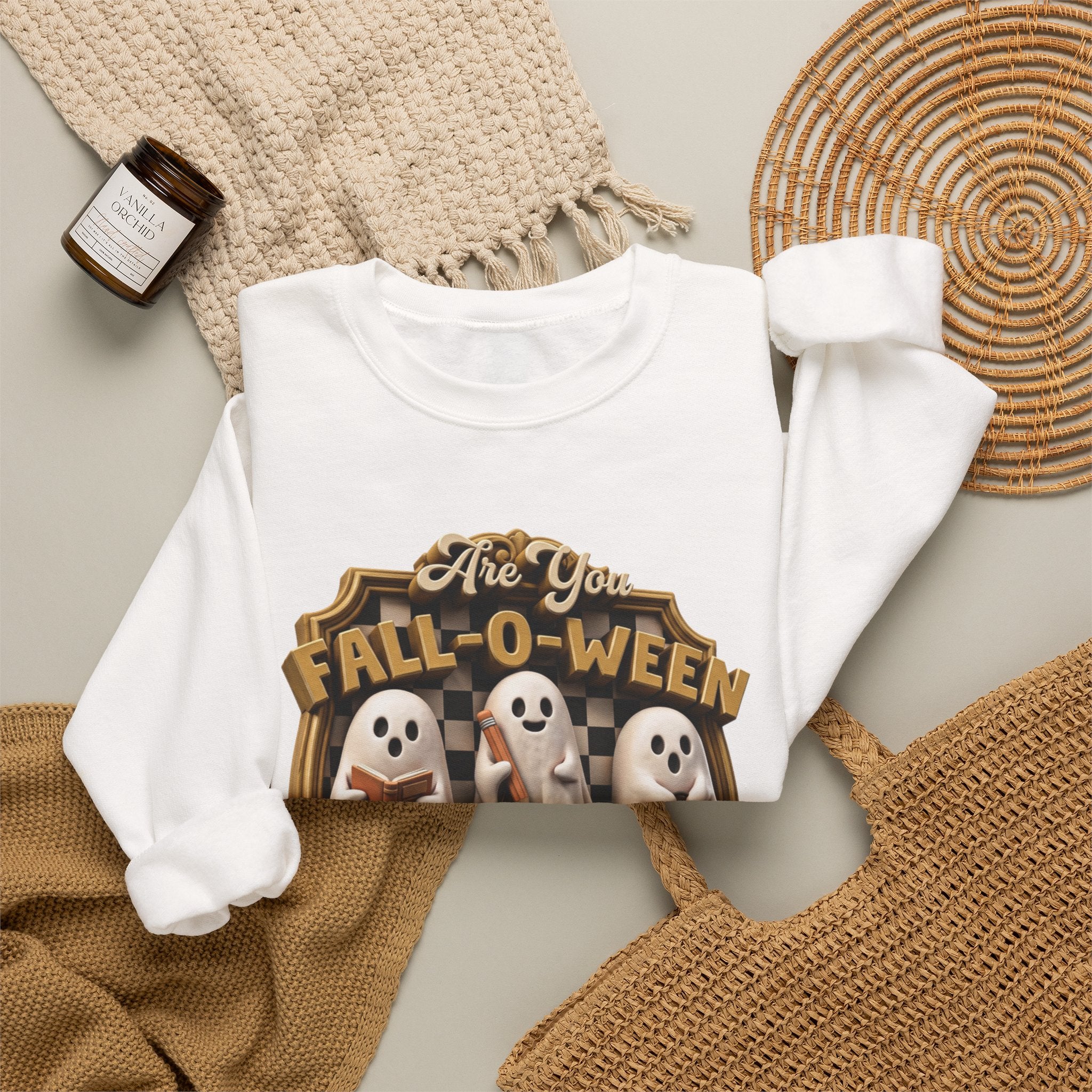 White crewneck sweatshirt styled flat with a candle — three sheet ghosts reading a book