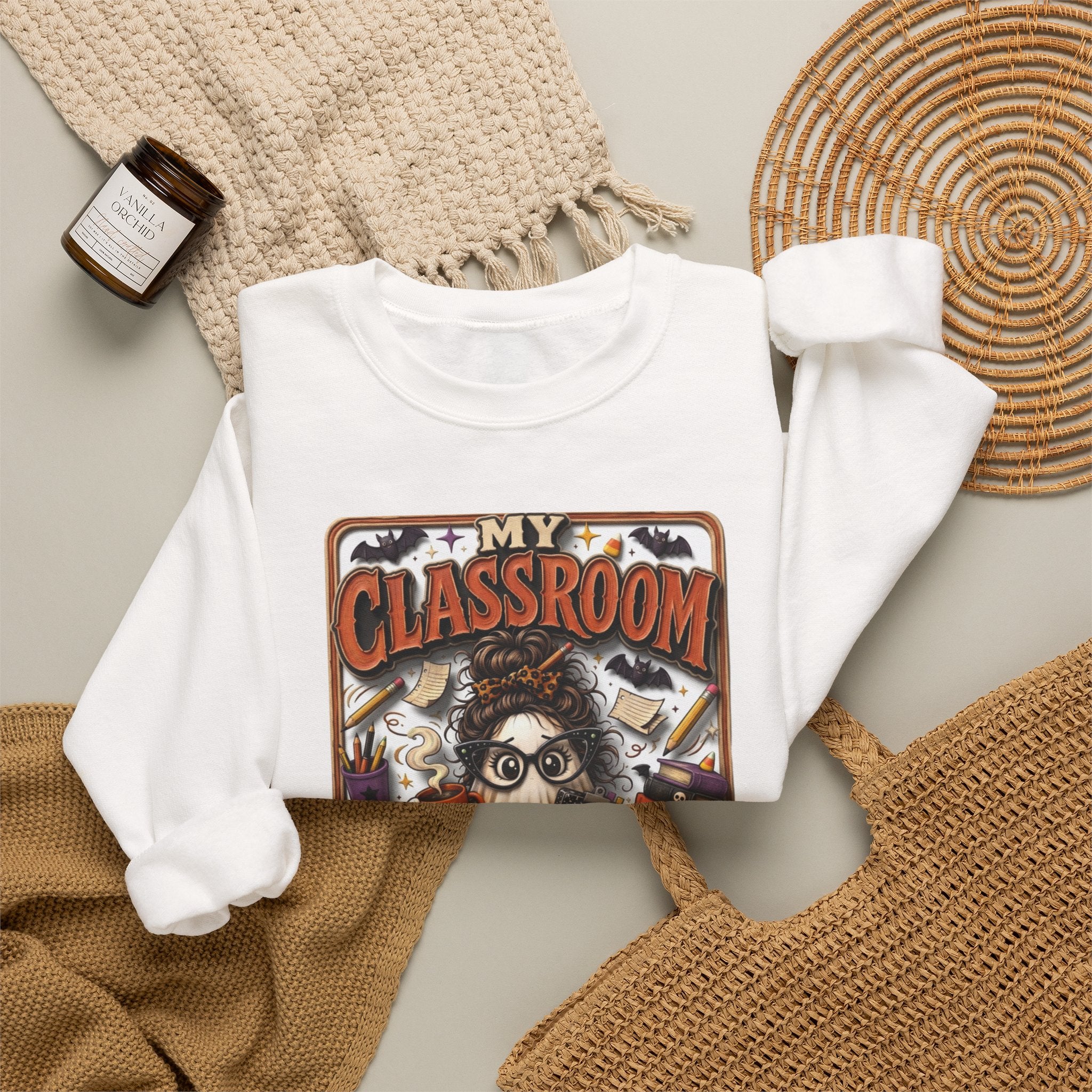 White crewneck sweatshirt styled flat with a candle — bespectacled ghost grading papers