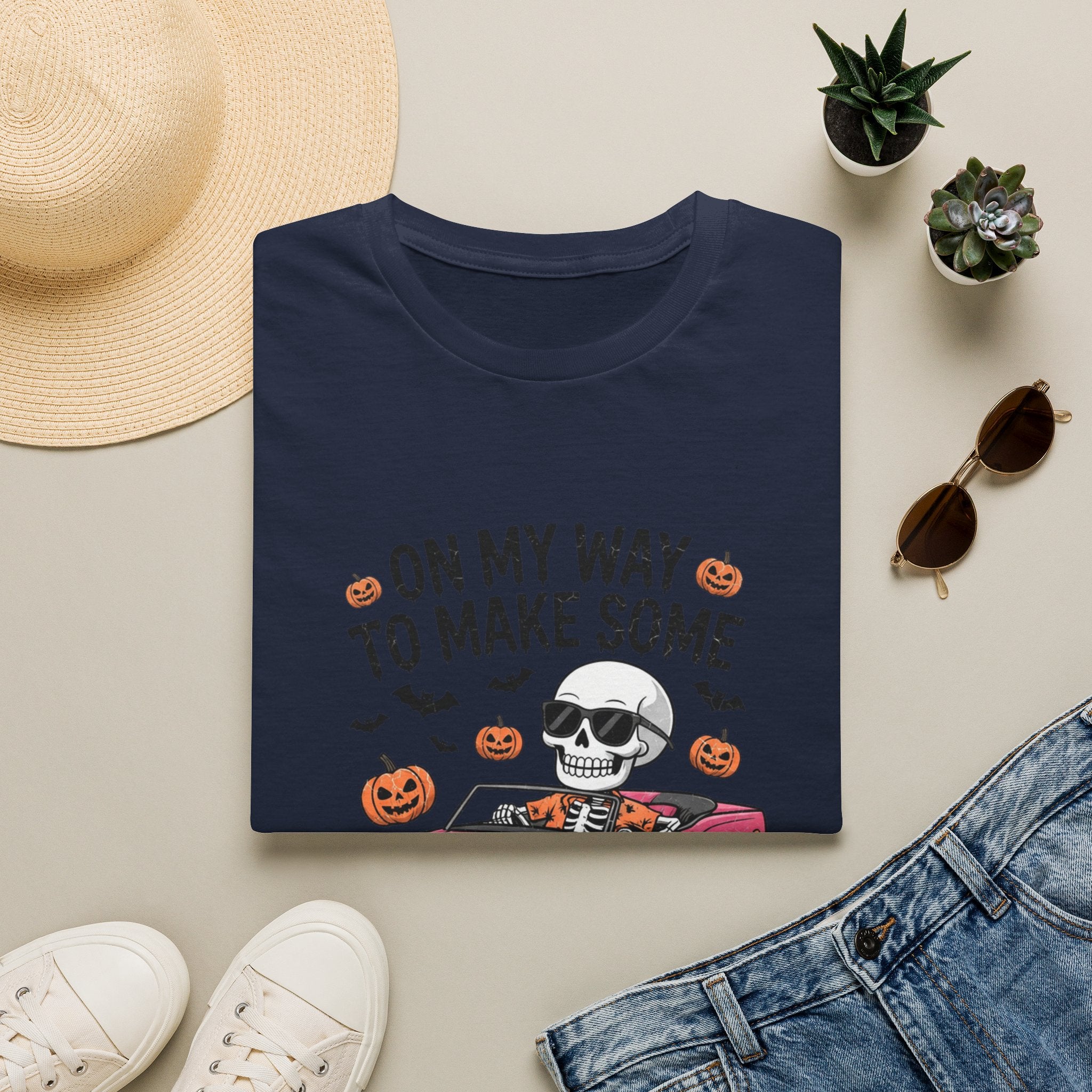 Navy t-shirt styled flat with a candle — pink convertible car and a skull