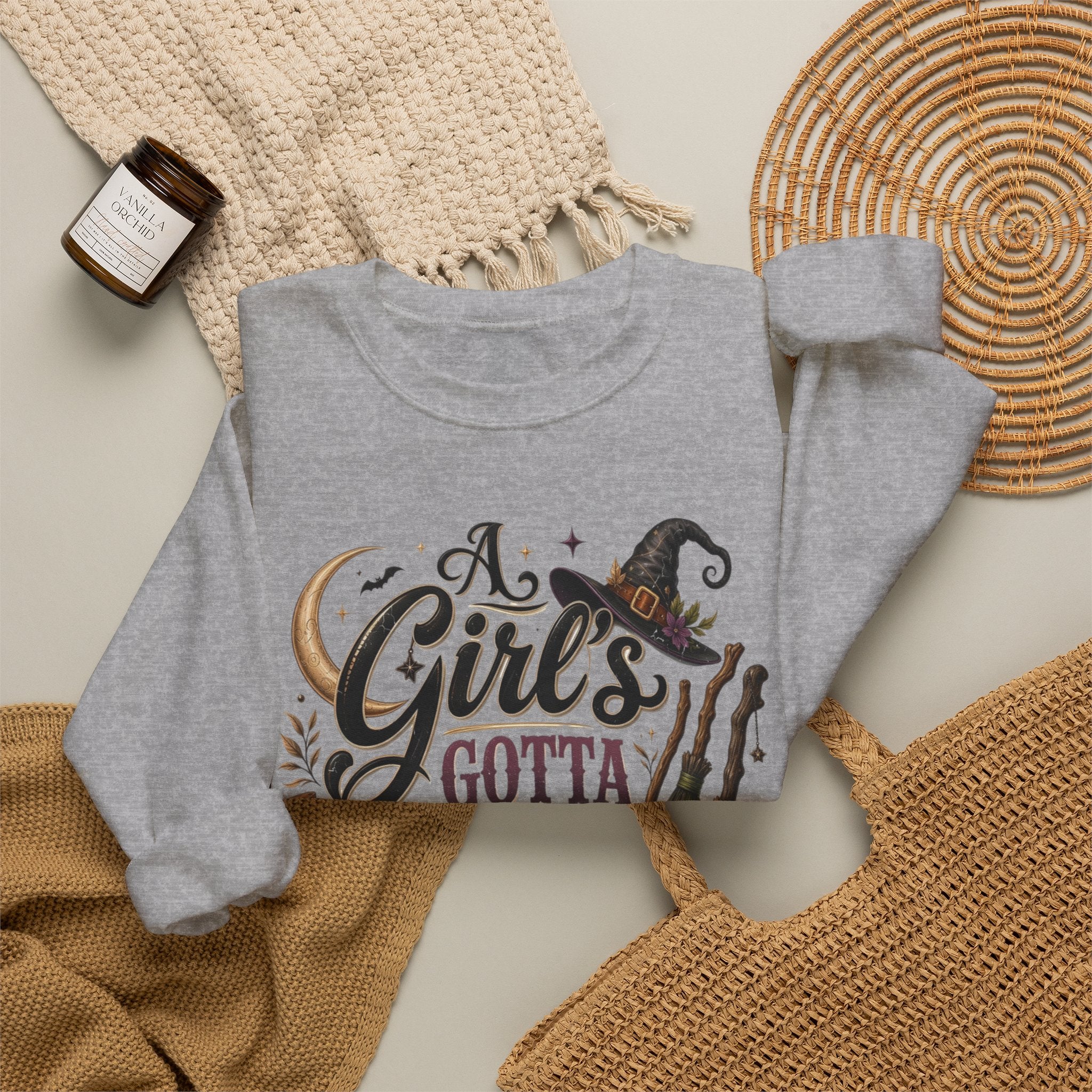 Sport Grey crewneck sweatshirt styled flat with a candle — hand-lettered A Girl's Gotta Have Options