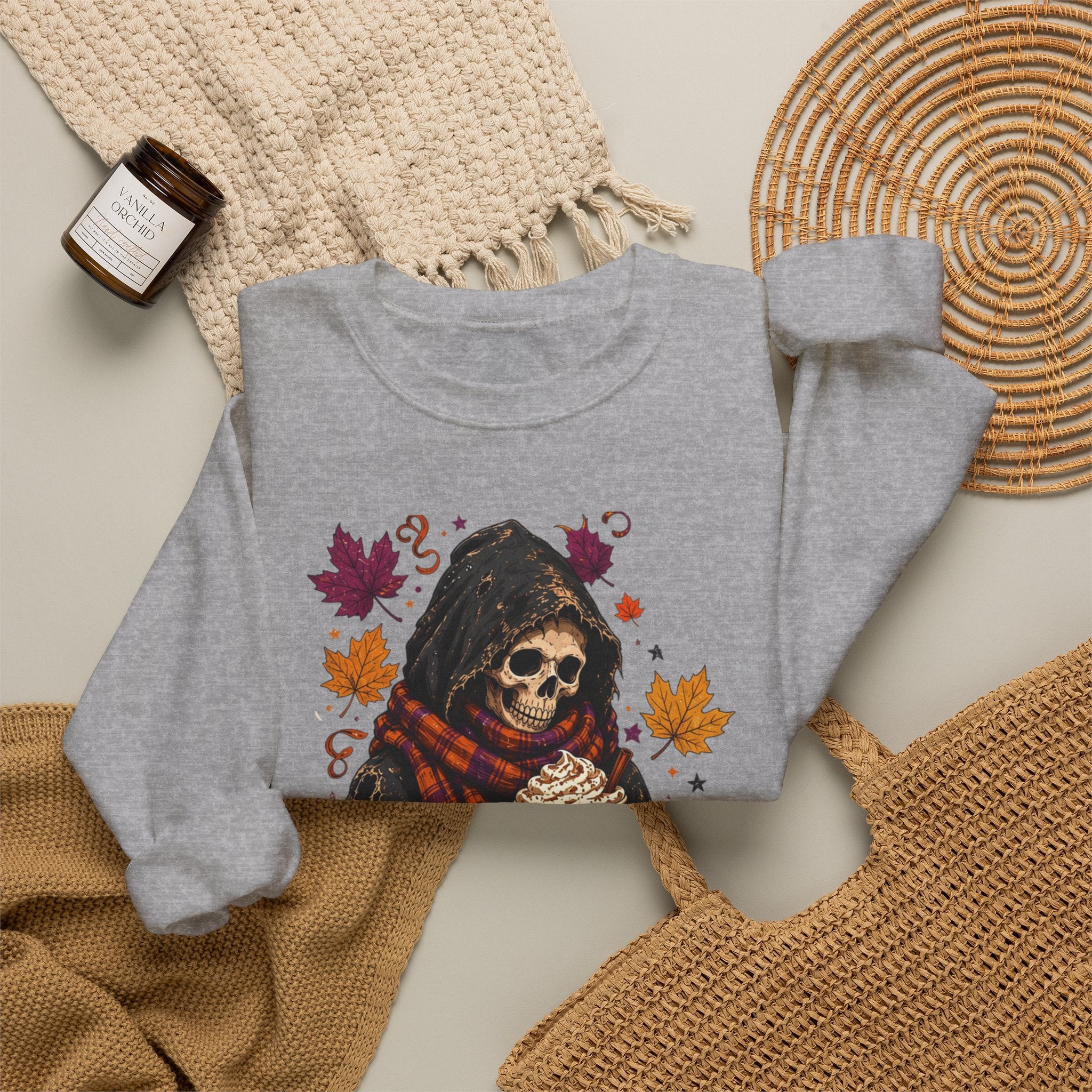 Sport Grey crewneck sweatshirt styled flat with a candle — hooded skeleton with pumpkin spice drink