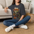 Dark Heather Grey t-shirt laid flat, printed with a skeletons and zombies crowded around a smoking grill