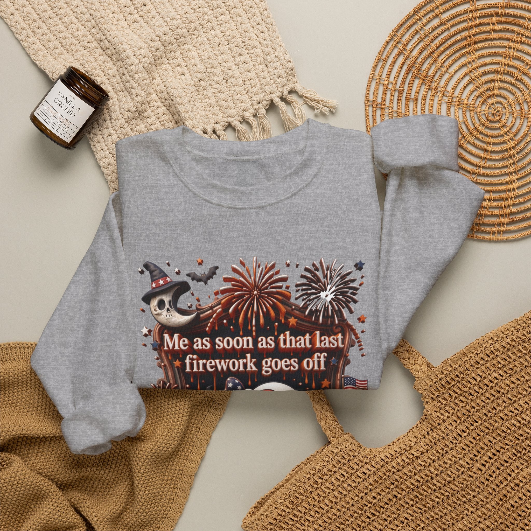 Sport Grey crewneck sweatshirt styled flat with a candle — wide-eyed ghost clutching a firework