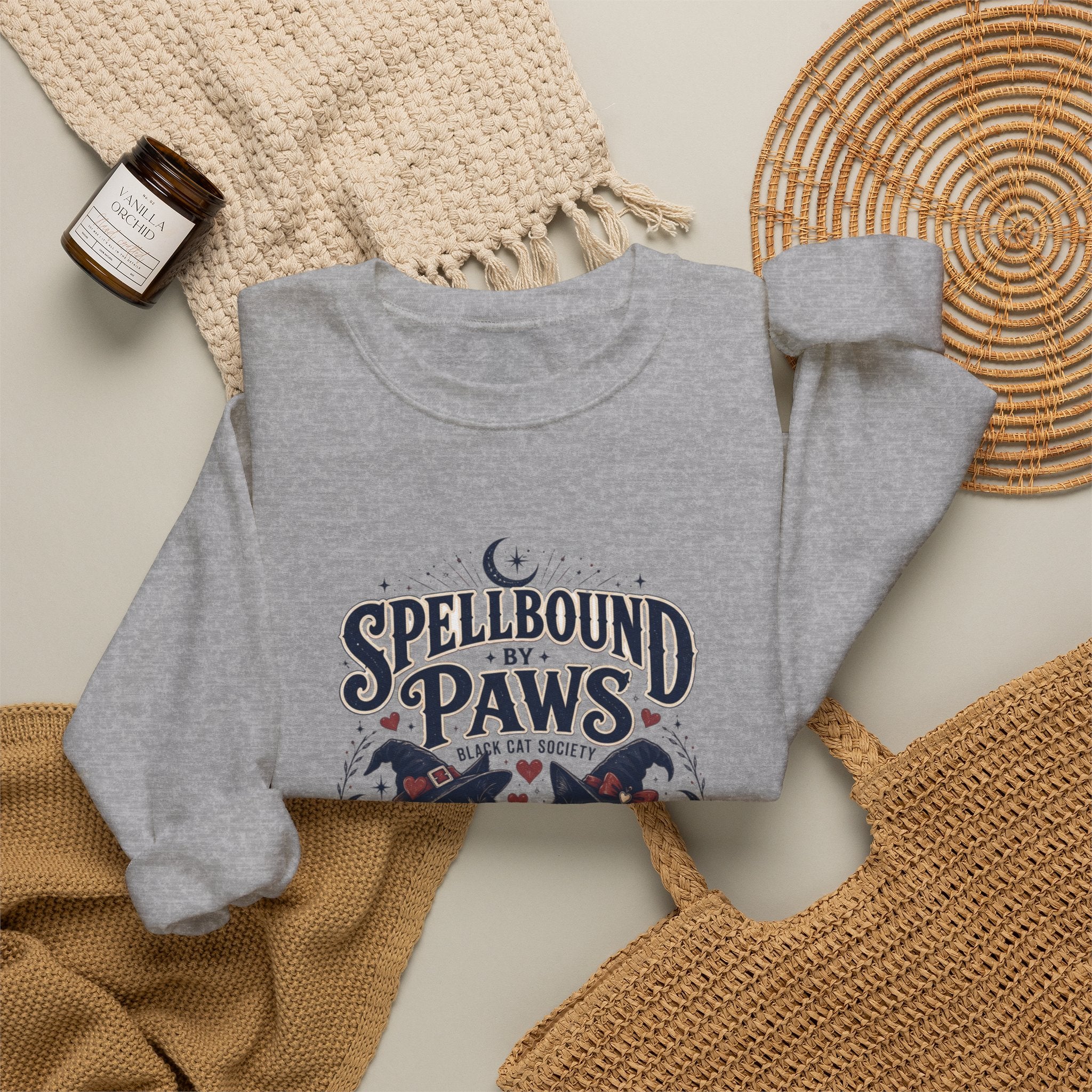 Sport Grey crewneck sweatshirt styled flat with a candle — two black cats in witch hats