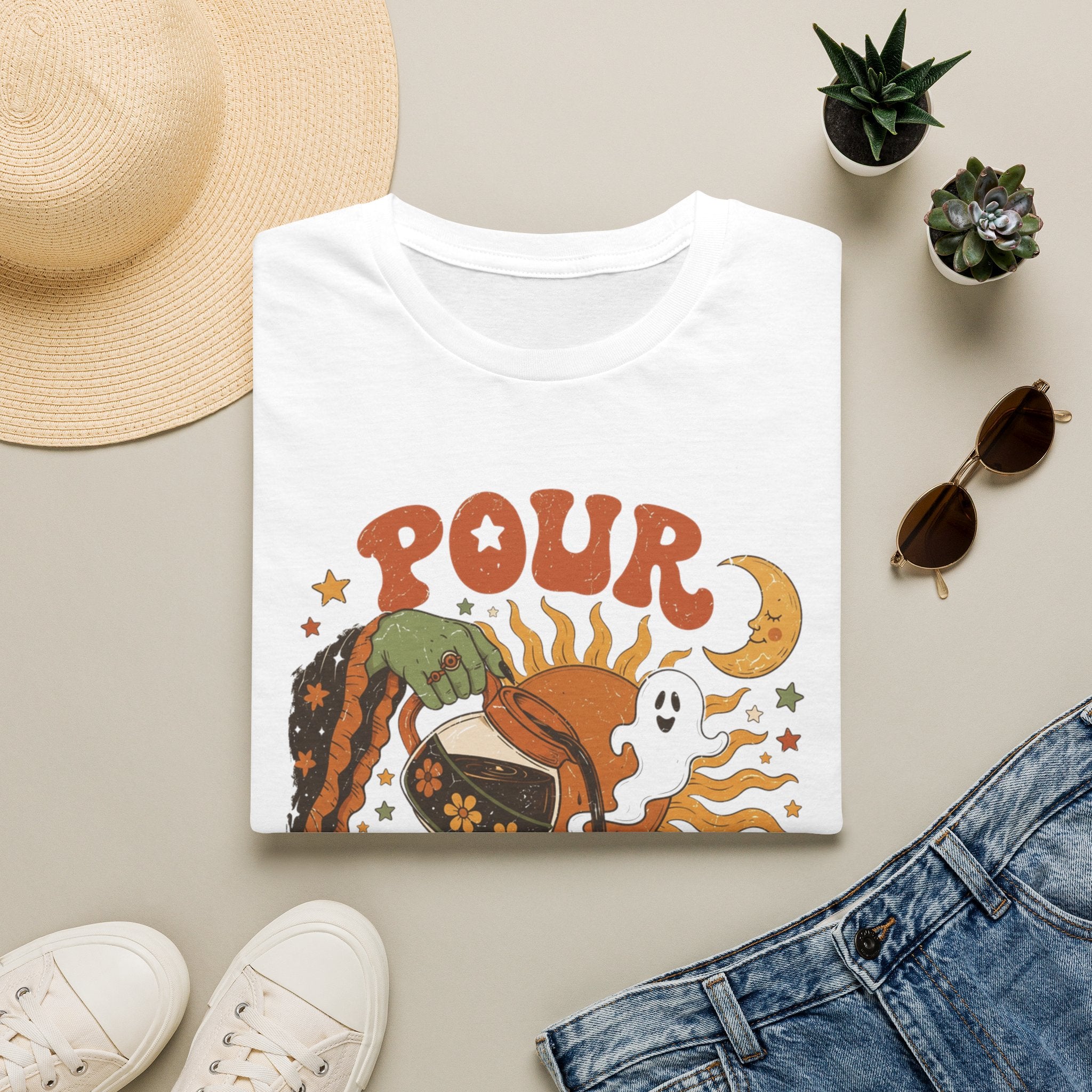 White t-shirt styled flat with a candle — green witch hand pouring coffee