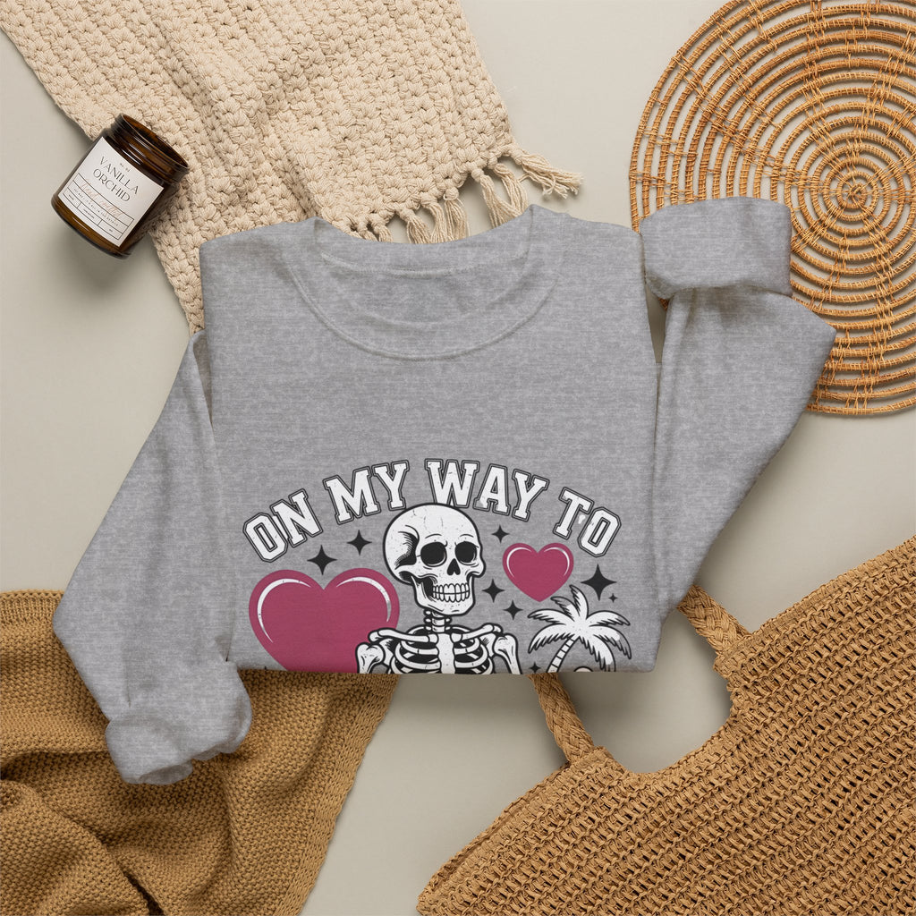 Sport Grey crewneck sweatshirt styled flat with a candle — line-drawn skeletons under pink hearts