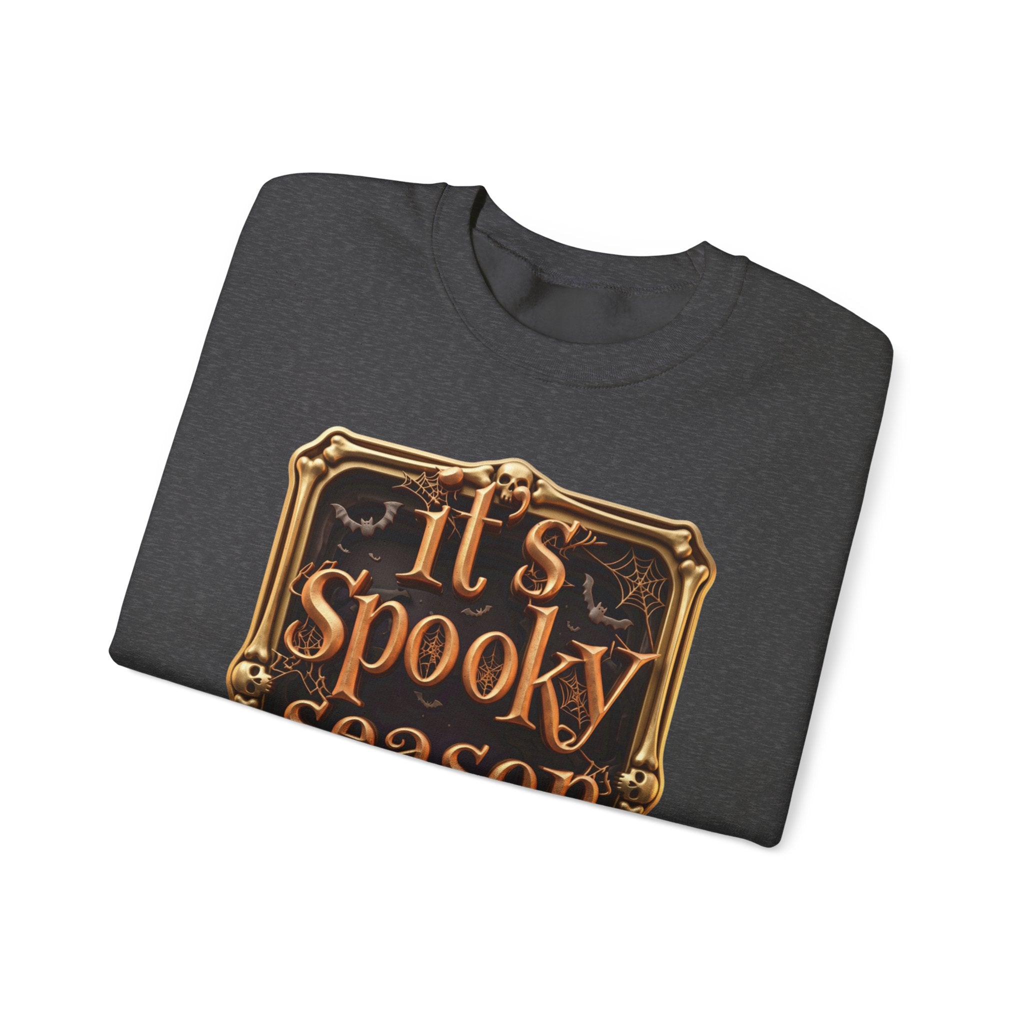 Dark Heather crewneck sweatshirt folded to show the copper serif lettering reads it's spooky season inside print
