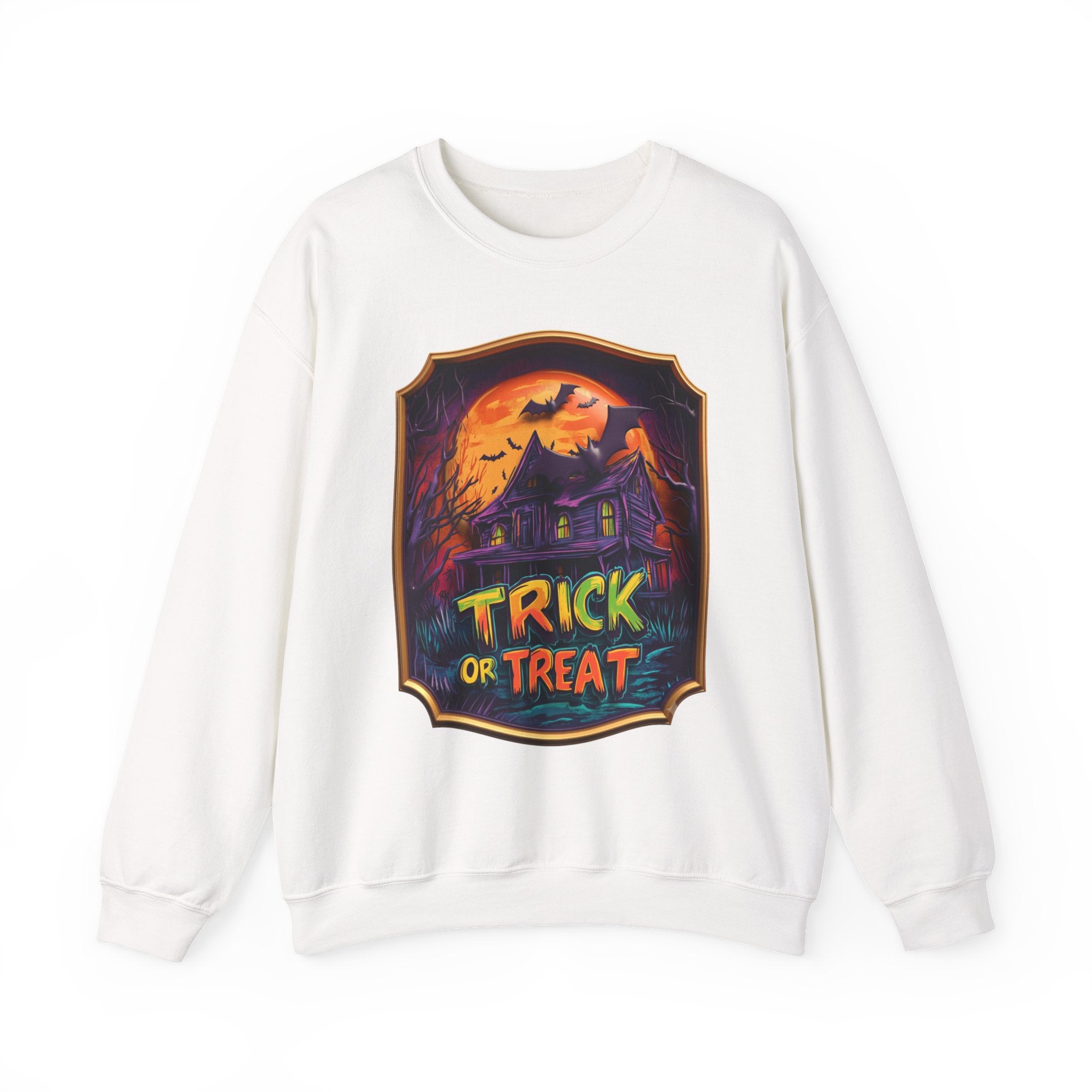 White crewneck sweatshirt laid flat, printed with a purple haunted mansion sits under a blazing orange moon