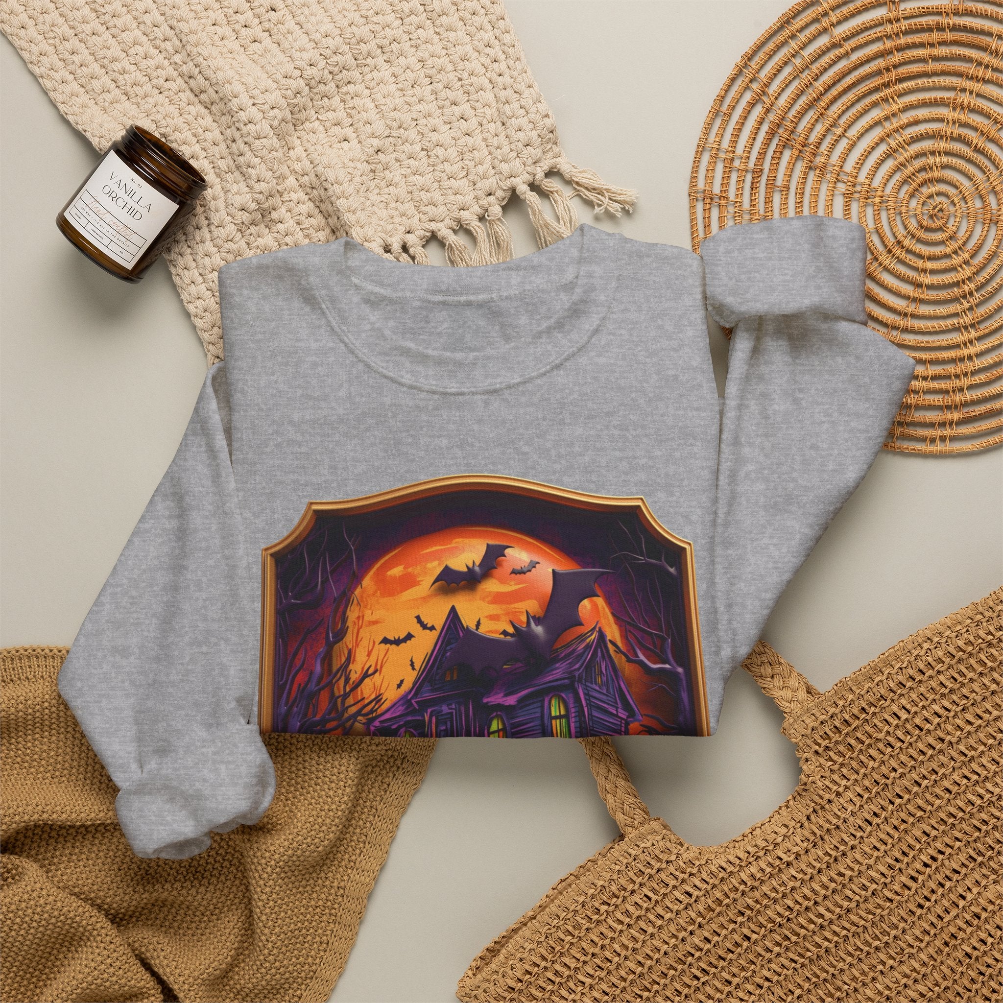 Sport Grey crewneck sweatshirt styled flat with a candle — haunted mansion under an orange moon