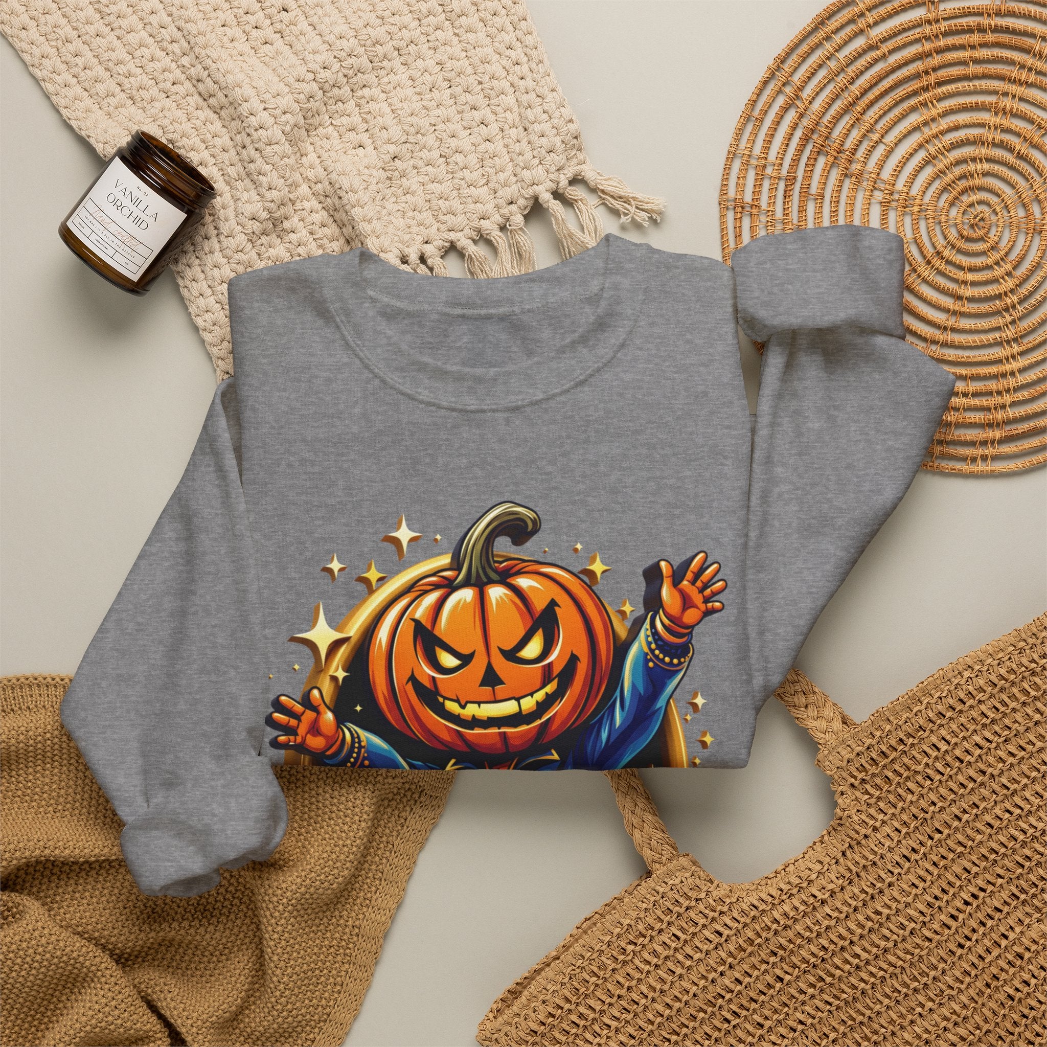 Graphite Heather crewneck sweatshirt styled flat with a candle — jack-o-lantern head in a blue jacket