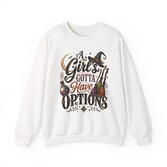 White crewneck sweatshirt laid flat, printed with a hand-lettered script reading a girl's gotta have options