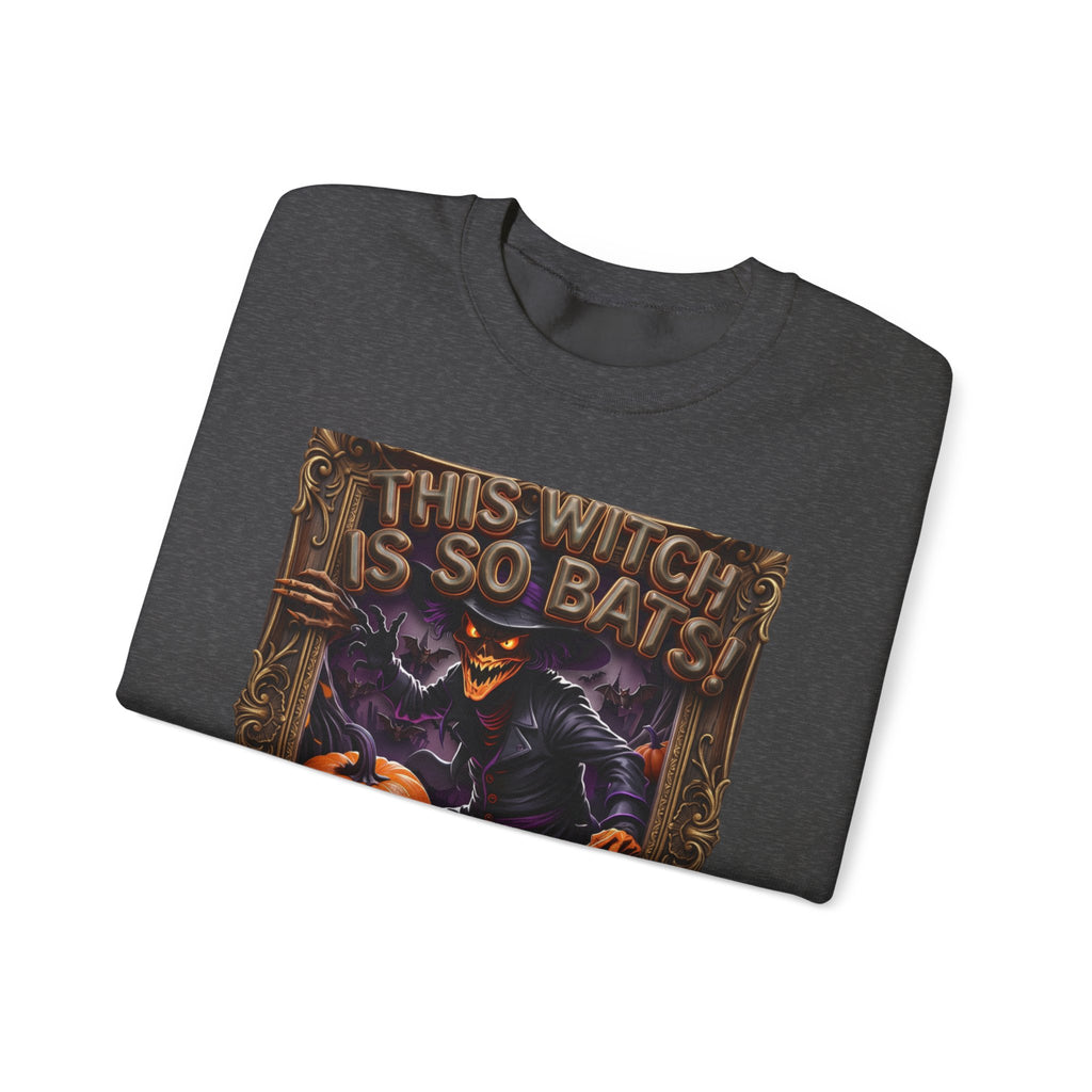 Dark Heather crewneck sweatshirt folded to show the grinning witch in a pointed hat looms over glowing print